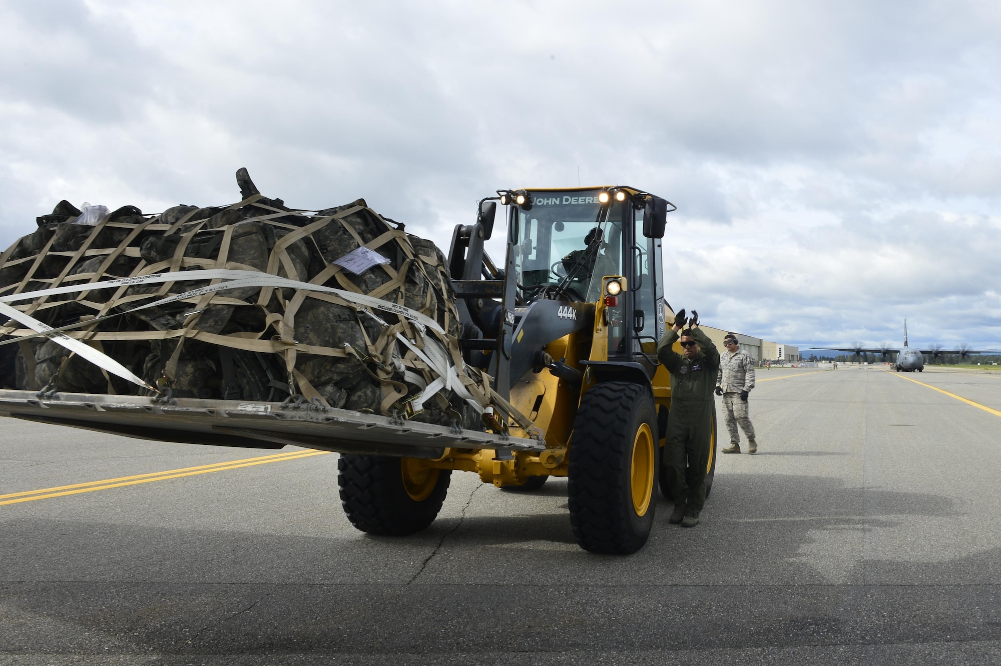 A 41st Airlift Squadron loadmaster directs a maintainer from the 19th Aircraft Maintenance Squadron as he uses a forlift to place a pallet loaded with military gear onto a C-130J in support of exercise Arctic Anvil at Ladd Army Airfield Alaska July 20, 2016. The 41st AS is conducting training in Alaska to prepare for the terrain present in austere locations. Alaska provides an uncontended airspace which allows aircrews to train more effectively without having to adjust to commercial flight patterns. (U.S. Air Force photo by Senior Airman Kaylee Clark)