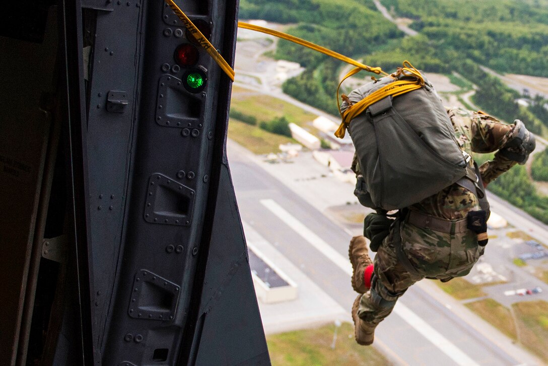 A soldier conducts a training jump out of a C-17 Globemaster III to prepare for Arctic Thunder Open House at Joint Base Elmendorf-Richardson, Alaska, July 20, 2016. The soldier is assigned to the 25th Infantry Division's 4th Brigade Combat Team. Air Force photo by Senior Airman James Richardson