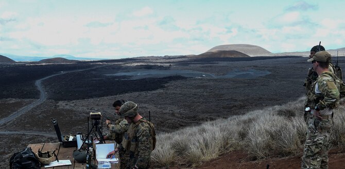 Marines from III Marine Expeditionary Forces call in close air support as a combat controller from the 353rd Special Operations Group oversees the training as a joint terminal attack controller instructor during RIMPAC to strengthen relationships and interoperability, Pohakuloa Training Area, Hawaii, July 15, 2016. (U.S. Air Force photo by 2nd Lt. Jaclyn Pienkowski/Released)