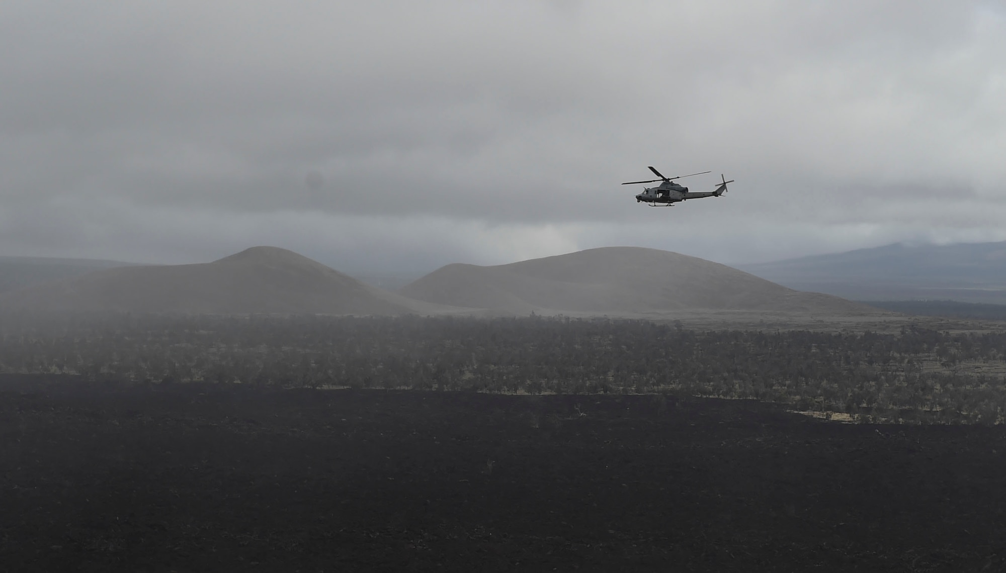 A UH-1Y Venom flies over a live-fire range during RIMPAC at the Pohakuloa  Training Area, Hawaii, July 15, 2016. (U.S. Air Force photo by 2nd Lt. Jaclyn Pienkowski/Released)