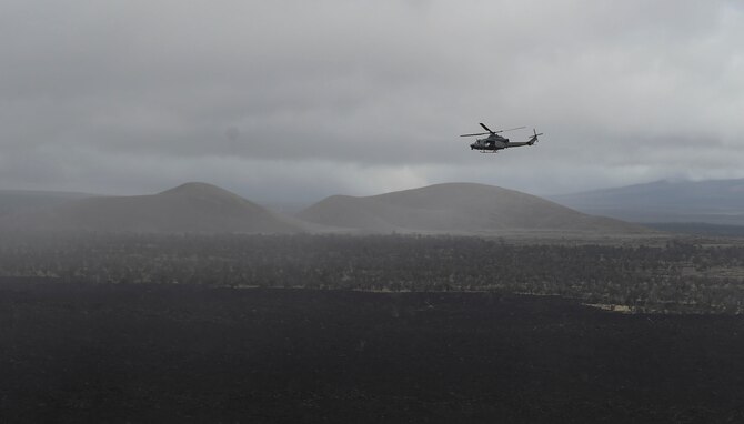 A UH-1Y Venom flies over a live-fire range during RIMPAC at the Pohakuloa  Training Area, Hawaii, July 15, 2016. (U.S. Air Force photo by 2nd Lt. Jaclyn Pienkowski/Released)