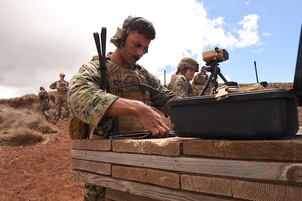 Marines from III Marine Expeditionary Forces call in close air support as a combat controller from the 353rd Special Operations Group oversees the training during RIMPAC exercises on Pohakuloa Training Area, Hawaii, July 15, 2016. (U.S. Air Force photo by 2nd Lt. Jaclyn Pienkowski/Not released)