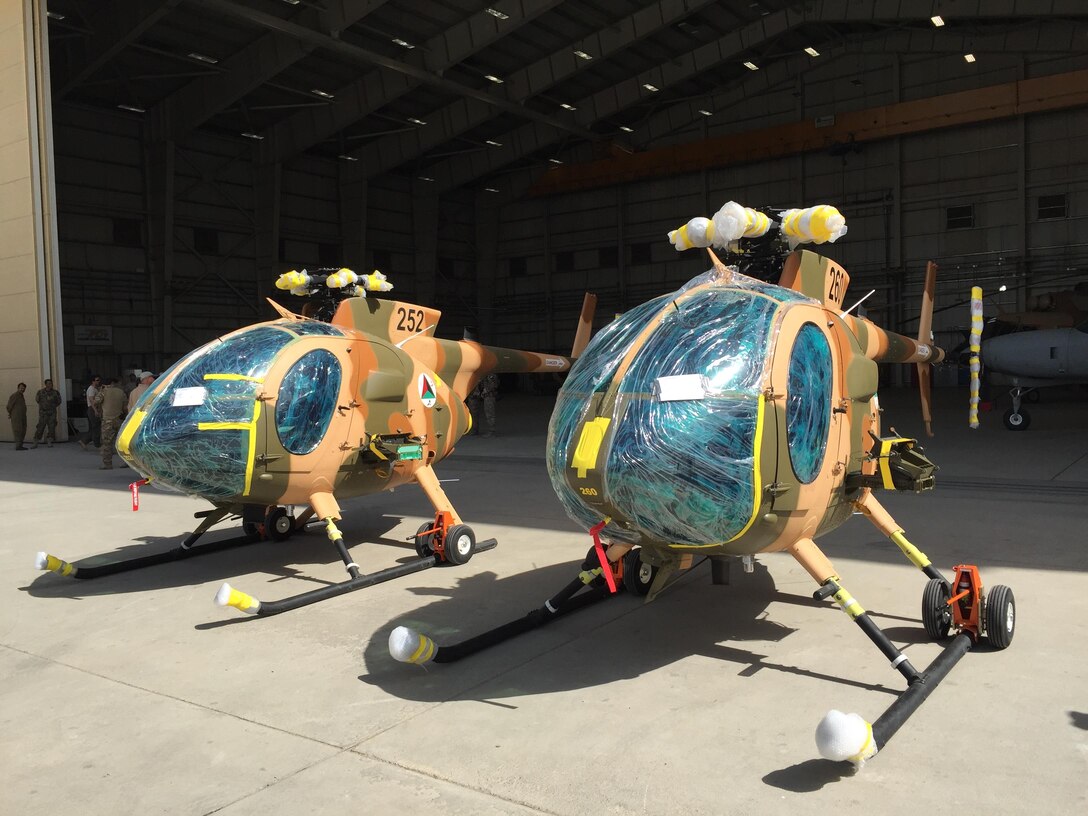 Two new MD-530 Cayuse Warrior helicopters, still with protective wrap on them, are seen at the 438th Air Expeditionary Wing/Train, Advise, Assist Command-Air in Kabul, Afghanistan, July 16, 2016. DoD photo by Lisa Ferdinando