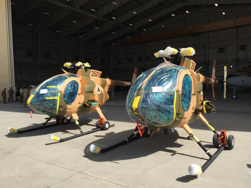 Two new MD-530 Cayuse Warrior helicopters, still with protective wrap on them, are seen at the 438th Air Expeditionary Wing/Train, Advise, Assist Command-Air in Kabul, Afghanistan, July 16, 2016. DoD photo by Lisa Ferdinando