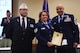 Jim Broe (left), American Legion representative, and Chief Master Sgt. Tiko Mazid (right), 62nd Airlift Wing command chief, present Tech. Sgt. Danita Welch, 62nd Medical Squadron health services manager, is presented with the American Legion Spirit of Service Award in Centralia, Wash., July 15, 2016. Welch, who has served for more than 20 years, was recognized for her service to others by the American Legion for her dedication as a foster parent to more than 50 children. (U.S. Air Force photo/Staff Sgt. Naomi Shipley) 