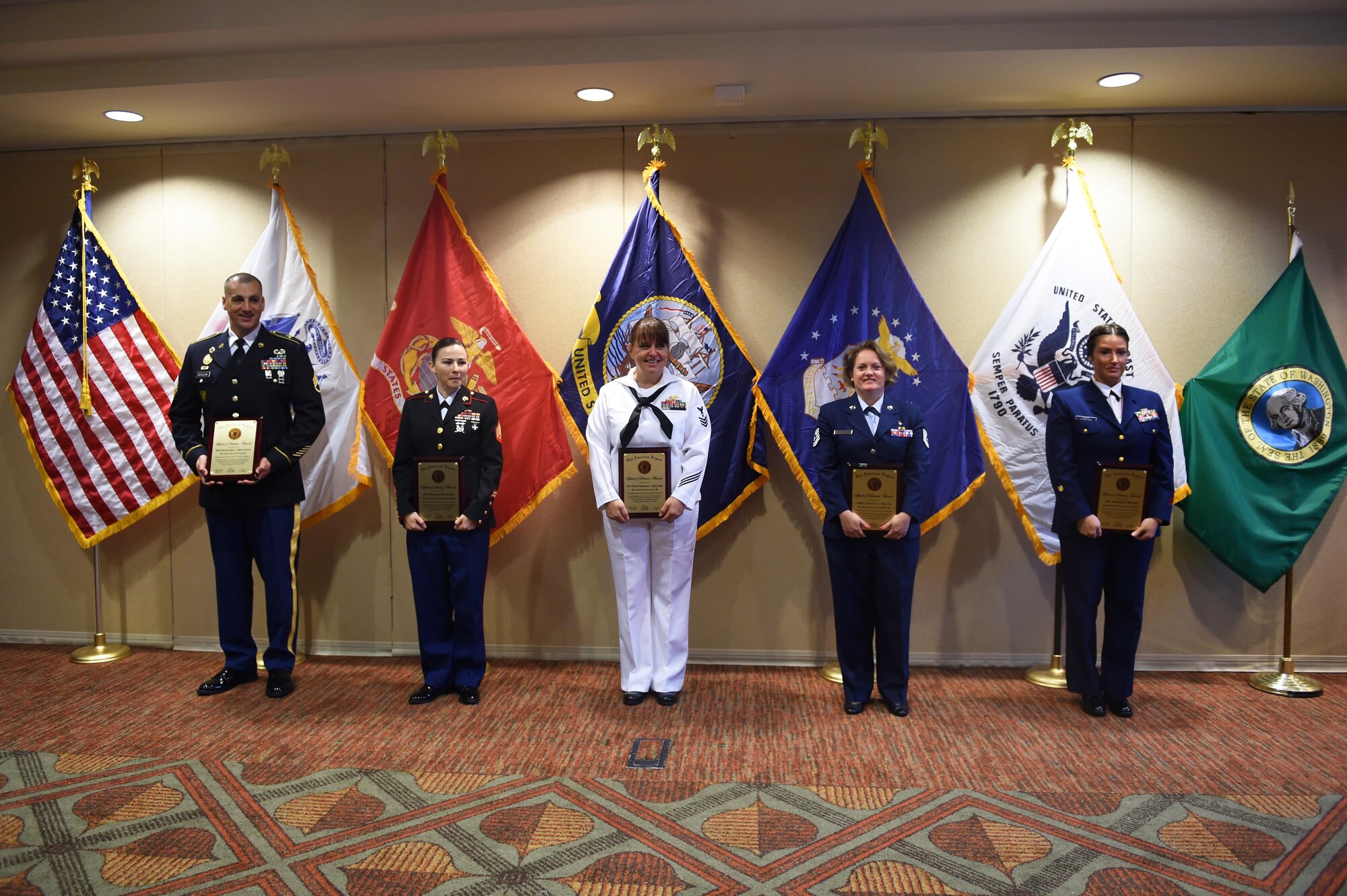 Service members from each branch of service hold their American Legion Spirit of Service Award after the Service to American Legion Service to America Banquet in Centralia, Wash., July 15, 2016. Each member, accompanied by their families and leadership, were honored for their continuous contributions to others. (U.S. Air Force photo/Staff Sgt. Naomi Shipley)
