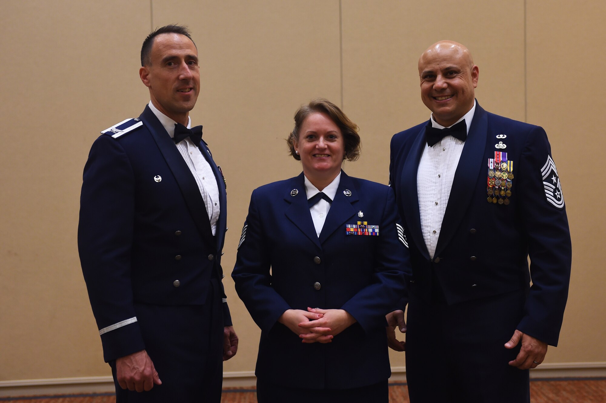 Col. Leonard Kosinksi (, 62nd Airlift Wing Commander, and Chief Master Sgt. Tiko Mazid (right), 62 AW command chief, stand with Tech. Sgt. Danita Welch,  62nd Medical Squadron Health Services Manager, prior to the American Legion Service to America Banquet in Centralia, Wash., July 15, 2016. Welch, a single mother, has fostered more than 50 children whose ages range from 11 months to 18 years old. (U.S. Air Force photo/Staff Sgt. Naomi Shipley)
