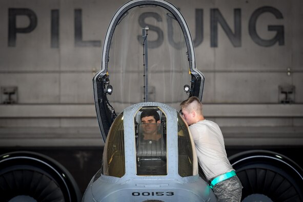 Maj. Gary Glojek, 25th Fighter Squadron pilot, and Airman Weston Meyer, 25th Aircraft Maintenance Unit crew chief, prepare for a combat search and rescue training flight on an A-10 Thunderbolt II at Osan Air Base, Republic of Korea, July 19, 2016. The CSAR flight is part of Exercise Pacific Thunder 16-2, a two-week long combined exercise designed to train U.S. and ROK aircrews and commanders to validate tactics, techniques and procedures of CSAR and suppression of enemy air defense. (U.S. Air Force photo by Staff Sgt. Jonathan Steffen/Released)