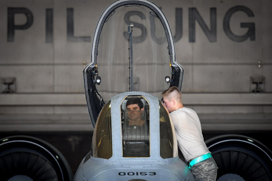 Maj. Gary Glojek, 25th Fighter Squadron pilot, and Airman Weston Meyer, 25th Aircraft Maintenance Unit crew chief, prepare for a combat search and rescue training flight on an A-10 Thunderbolt II at Osan Air Base, Republic of Korea, July 19, 2016. The CSAR flight is part of Exercise Pacific Thunder 16-2, a two-week long combined exercise designed to train U.S. and ROK aircrews and commanders to validate tactics, techniques and procedures of CSAR and suppression of enemy air defense. (U.S. Air Force photo by Staff Sgt. Jonathan Steffen/Released)