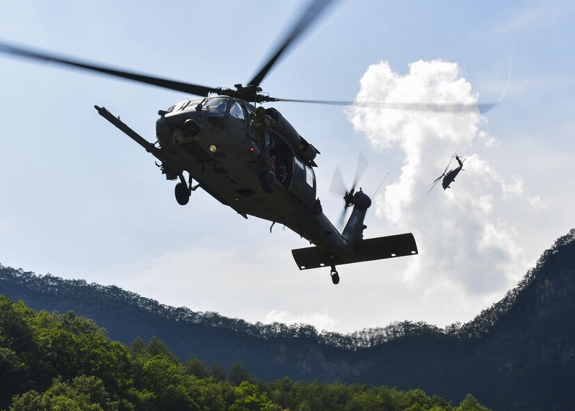 An HH-60 Pave Hawk assigned to the 33rd Rescue Squadron, Kadena Air Base, Japan, descends for a landing while a second HH-60 provides aerial coverage from above during a combat search and rescue training mission during Exercise Pacific Thunder 16-2 in the Republic of Korea, July 19, 2016. The two-week long exercise brought together units from around Pacific Air Forces to train aircrews and commanders to validate tactics, techniques and procedures used for CSAR and suppression of enemy air defense. (U.S. Air Force photo by Senior Airman Victor J. Caputo/Released)