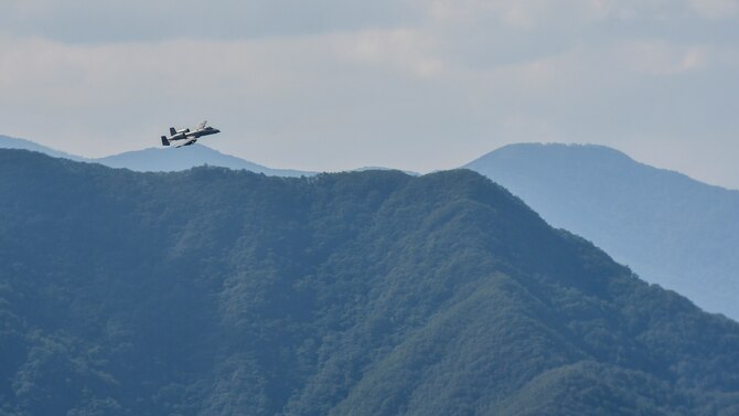 An A-10 Thunderbolt II assigned to the 25th Fighter Squadron crests over a hill while providing air coverage for a combat search and rescue team during Exercise Pacific Thunder 16-2 in the Republic of Korea, July 19, 2016. The two-week long combined exercise is designed to train U.S. and ROK aircrews and commanders to validate tactics, techniques and procedures used for CSAR and suppression of enemy air defense. The units and aircraft involved in the exercise include A-10s and F-16 Fighting Falcons from the 51st Fighter Wing, Osan Air Base, Republic of Korea; F-16s from the 8th Fighter Wing, Kunsan Air Base, ROK; HH-60 Pave Hawks, E-3 Sentrys, and a KC-135 Stratotanker from the 18th Wing, Kadena AB, Japan; and U-2 Dragon Ladys from 7th Air Force alongside more than 200 ROK air force personnel and 22 ROKAF aircraft. (U.S. Air Force photo by Senior Airman Victor J. Caputo/Released)