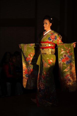 A model for The Red Carpet Event of Iwakuni 2016, displays a Japanese traditional style dress on the runway at the Egretta restaurant in Iwakuni, Japan, July 16, 2016. Models displayed hair styles, make-up and different clothing styles from various businesses to guests attending the event. (U.S. Marine Corps photo by Lance Cpl. Joseph Abrego)