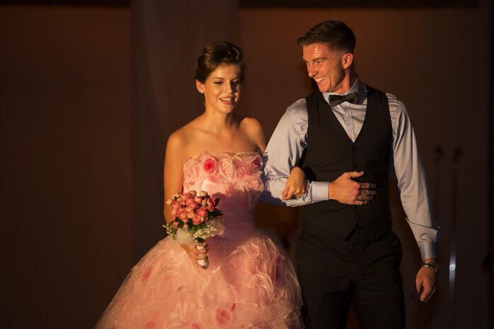 U.S. Marine Corps Cpl. David Bickel, combat correspondent for the American Forces Network at Marine Corps Air Station Iwakuni, Japan, walks Emily Paige Gilbert, a model for The Red Carpet Event of Iwakuni 2016, down the runway at the Egretta restaurant July 16, 2016. Egretta hosted The Red Carpet Event of Iwakuni 2016 featuring a red carpet photo shoot, buffet, fashion show, magic show and an after party. (U.S. Marine Corps photo by Lance Cpl. Joseph Abrego) 