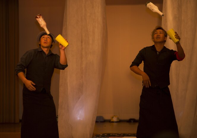 Two performers for The Red Carpet Event of Iwakuni 2016 at the Egretta restaurant in Iwakuni, Japan, display their talents to guests in attendance July 16, 2016.  The event featured a red carpet photo shoot, buffet, fashion show, magic show and an after party. (U.S. Marine Corps photo by Lance Cpl. Joseph Abrego)
