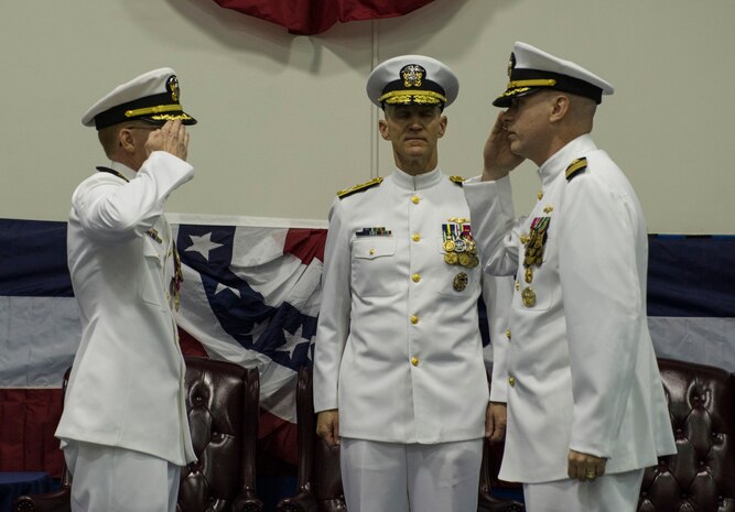 Capt. David A. Lott, right, takes command of the Naval Nuclear Power Training Unit Charleston with a salute to his predecessor, Capt. Robert E. Hudson, while Adm. James F. Caldwell, Jr., Naval Nuclear Propulsion director, presides over the change of command July 15, 2016, in the Bowman Center at Joint Base Charleston – Weapons Station, S.C. Lott is coming from the Office of Assistant Secretary of Defense for Nuclear, Chemical and Biological Defense Programs in Washington D.C, where he served as the Office for Countering Nuclear Threats director. Hudson replaced Capt. Timothy Sparks as the Joint Base Charleston deputy commander and Naval Support Activity Charleston commander. (U.S. Air Force photo/Airman 1st Class Kevin West)