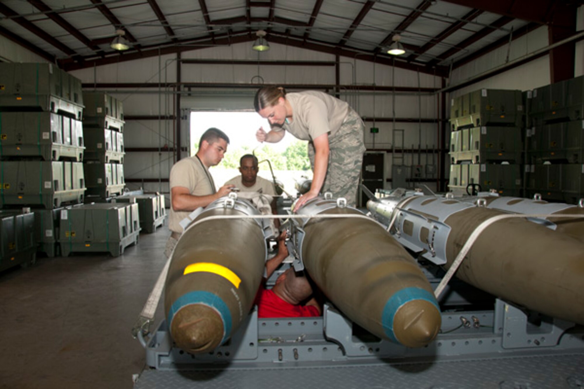 Virginia Air National Guard Tech. Sgt. Kenneth Stanley, Staff Sgt. Louis Jackson and Staff Sgt. Kerri White, 192nd Maintenance Squadron ordnance maintenance mechanics, and U.S. Air Force Airman 1st Class Randal Trosky, 1st Maintenance Squadron ordinance maintenance mechanic, train together as a team by building eight Mark 83 inert bombs during an exercise on July 10, 2016 at Joint Base Langley-Eustis, Virginia. This exercise will support the commemoration of Maj. Gen. Billy Mitchell’s bombing of the German battleship, SMS Ostfriesland, off of the Virginia Capes, July 1921. Billy Mitchell, who is often referred to as the Father of the Air Force, sunk the SMS Ostfriesland to prove a case for the power of an independent air service. (U.S. Air National Guard photo by Master Sgt. Carlos J. Claudio)