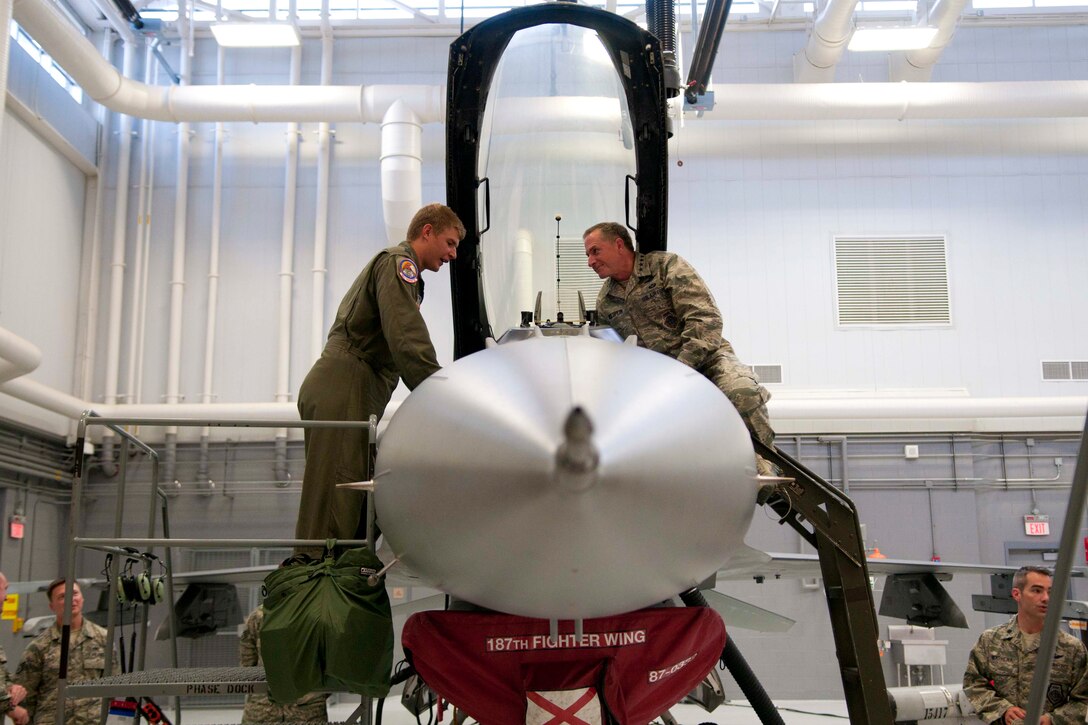 Capt. Richard Brennan, 187th Fighter Wing fighter pilot, shows Gen. David L. Goldfein, Chief of Staff of the Air Force, the improved avionics systems in the wing's F-16 Fighting Falcon Aircraft July 19, 2016 at the Montgomery Regional Air National Guard Base. Goldfein visited the wing to learn about the wing's mission, meet Airmen, and thank them for their service. (U.S. Air National Guard photo by Staff Sgt. Jared Rand)