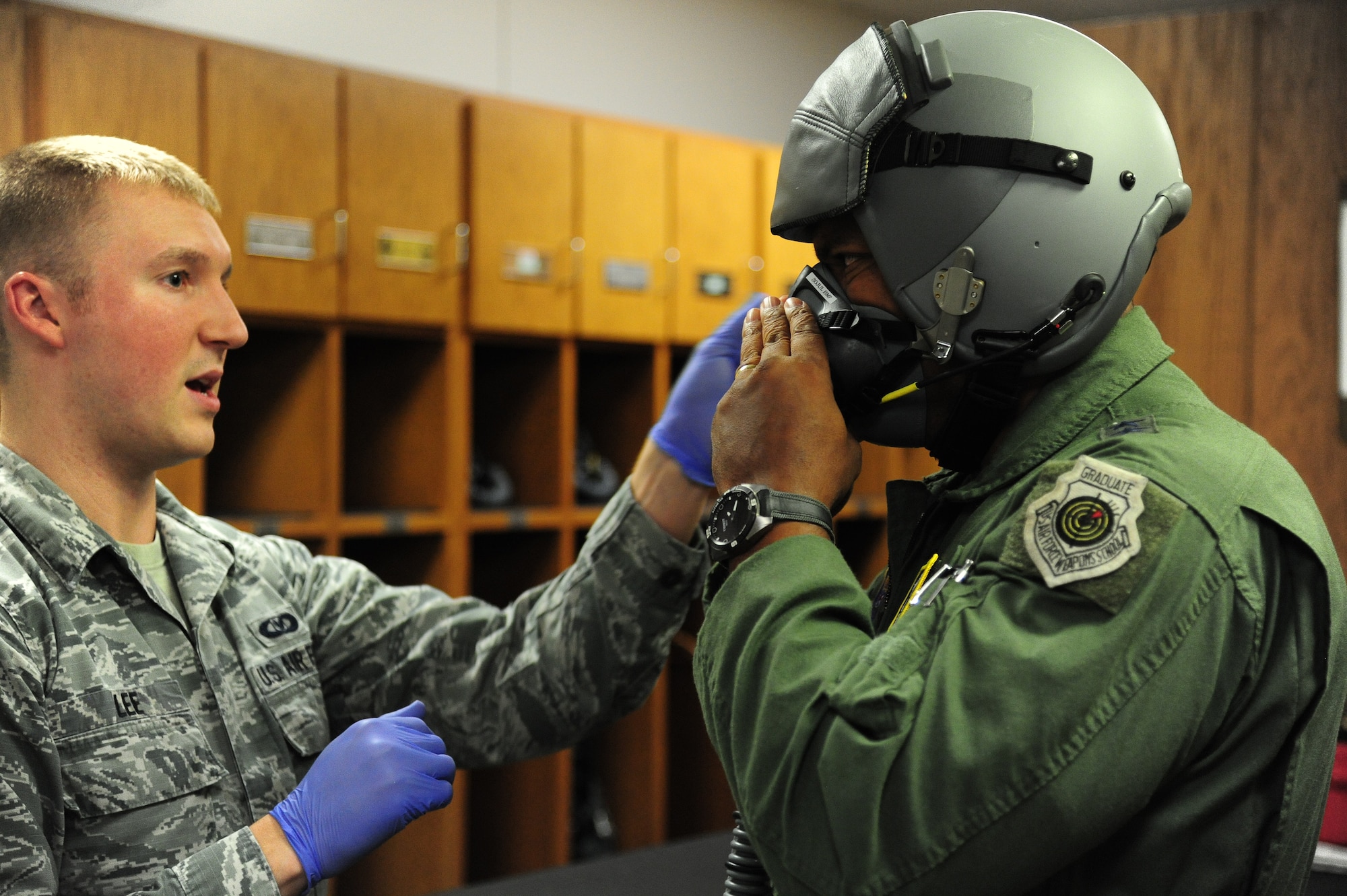 U.S. Air Force Senior Airman Steven Lee, an aircrew flight equipment technician with the 509th Operations Support Squadron, fits U.S. Air Force Maj. Gen. Richard M. Clark, the 8th Air Force commander, with an MBU-20/P soft-shell mask at Whiteman Air Force Base, Mo., July 13, 2016. During his visit to Whiteman, Clark experienced his first flight in a B-2 Spirit. (U.S. Air Force photo by Senior Airman Joel Pfiester)