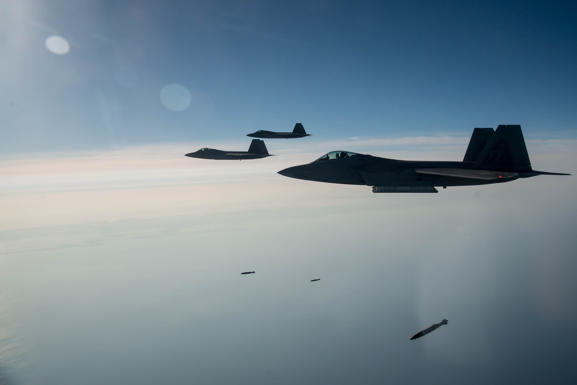 94th Fighter Squadron F-22A Raptor pilots drop Joint Direct Attack Munitions during the 95th anniversary of Gen. William Billy Mitchell bombing the Ostfriesland at Langley Air Force Base, Va., July 21, 2016. Mitchell and the 1st Provisional Air Brigade demonstrated to the world the superiority of air power by sinking the famous, unsinkable, Ostfriesland, a captured German battleship. (U.S. Air Force photo by Staff Sgt. J.D. Strong II)