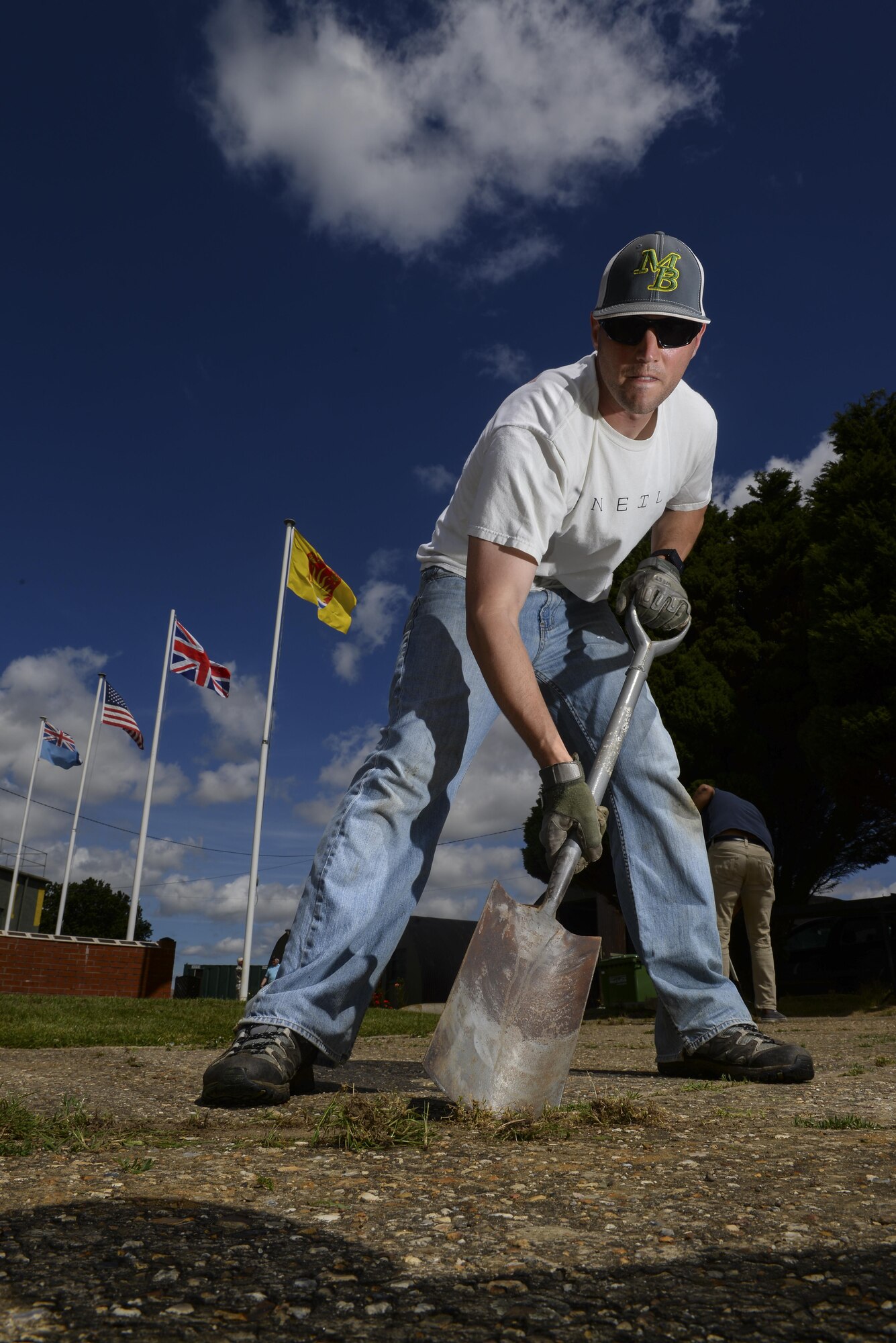 U.S. Air Force Tech. Sgt. David West, 100th Civil Engineer Squadron commander support staff NCO, uses a shovel to remove weeds from a side walk July 17, 2016, at the RAF Rougham Tower Museum in Bury St. Edmunds, England. West and other members from Team Mildenhall’s Air Force Sergeants Association volunteered to clean up the museum. (U.S. Air Force photo by Staff Sgt. Micaiah Anthony)
