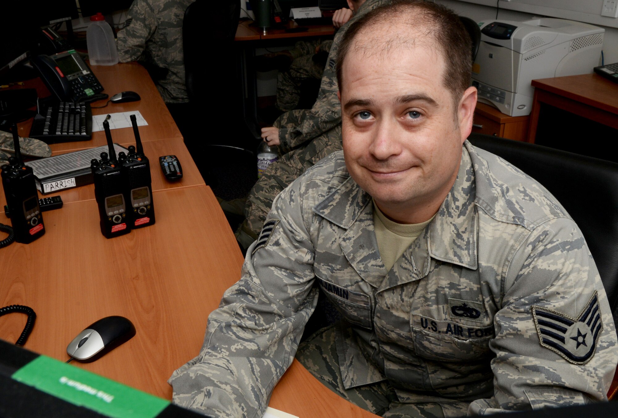 U.S. Air Force Staff Sgt. Nicholas Benjamin, 100th Maintenance Group maintenance operations center lead weapons system coordinator, works at his desk July 21, 2016, on RAF Mildenhall, England. Benjamin was submitted for the SquareD Spotlight for being an outstanding member of Team Mildenhall. (U.S. Air Force photo by Airman 1st Class Tenley Long) 