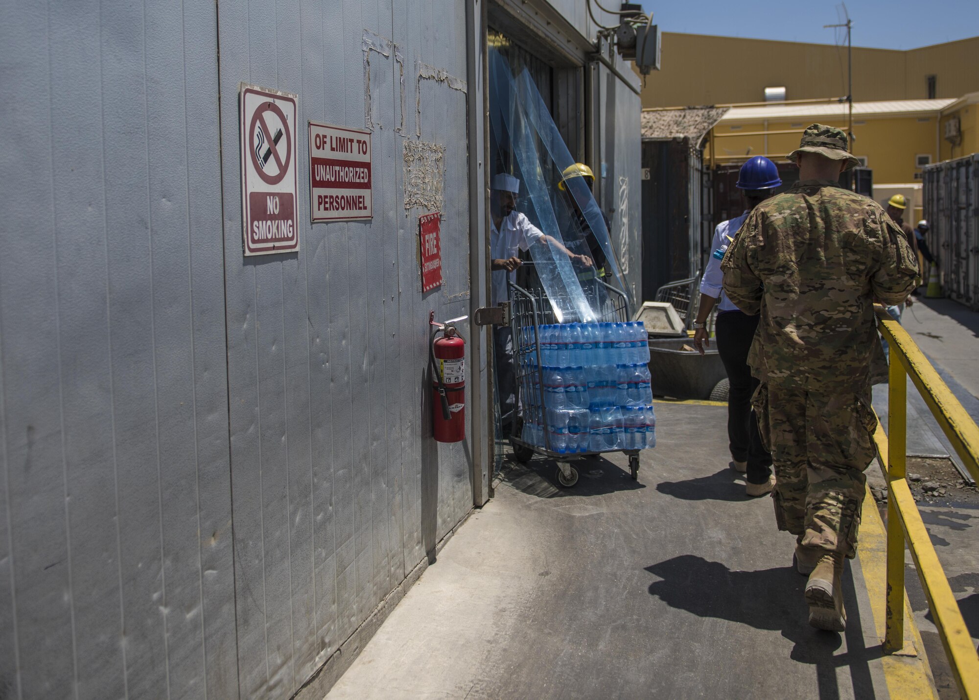 Tech Sgt. Rusty Thomas, 455th Expeditionary Medical Group public health technician, walks to a freezer to continue his inspection, Bagram Airfield, Afghanistan, July 21, 2016. Thomas inspects public facilities to ensure that they are sanitary, comply with food code, inspect for infestations, and check the overall cleanliness of the complex. (U.S. Air Force photo by Senior Airman Justyn M. Freeman)