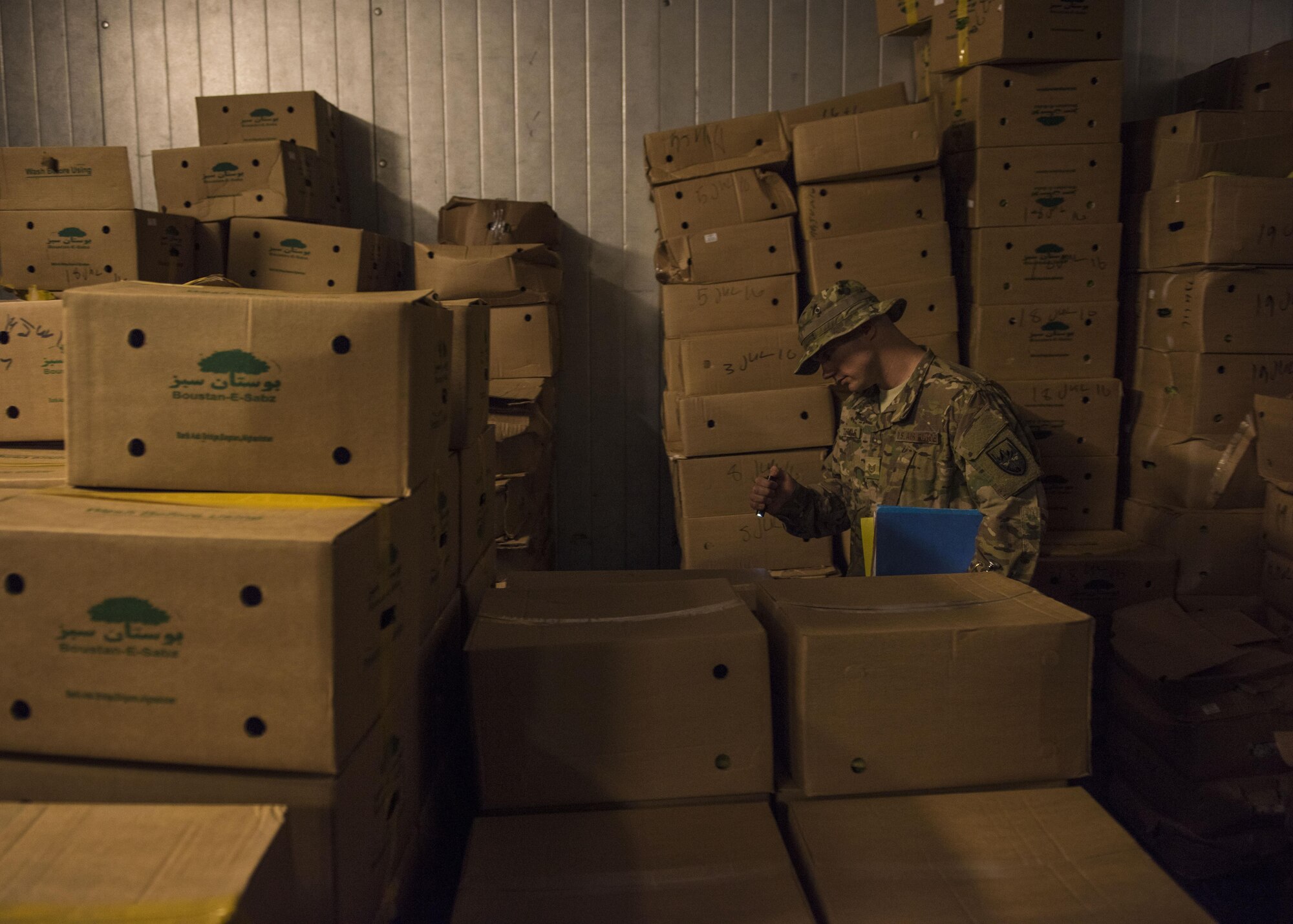 Tech Sgt. Rusty Thomas, 455th Expeditionary Medical Group public health technician, inspects a freezer, Bagram Airfield, Afghanistan, July 21, 2016. Thomas inspects public facilities to ensure that they are sanitary, and comply with food code standards. (U.S. Air Force photo by Senior Airman Justyn M. Freeman)