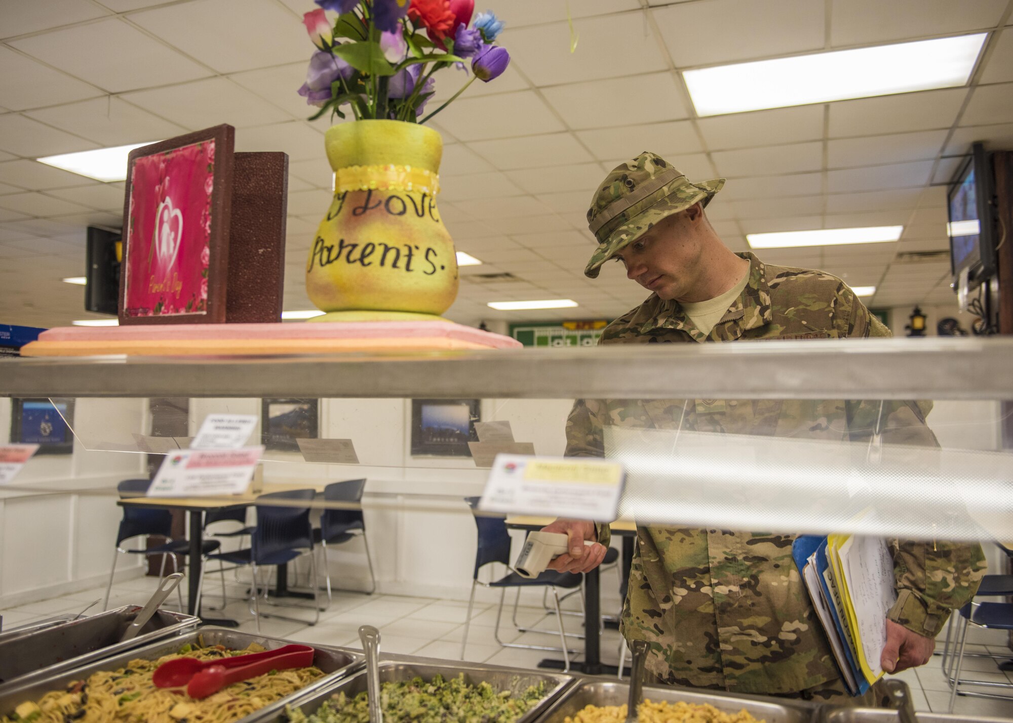 Tech Sgt. Rusty Thomas, 455th Expeditionary Medical Group public health technician, checks food temperature with an infrared thermometer, Bagram Airfield, Afghanistan, July 21, 2016. Thomas performs monthly inspections to check the overall cleanliness of the building and to ensure food code standards are being met. (U.S. Air Force photo by Senior Airman Justyn M. Freeman)