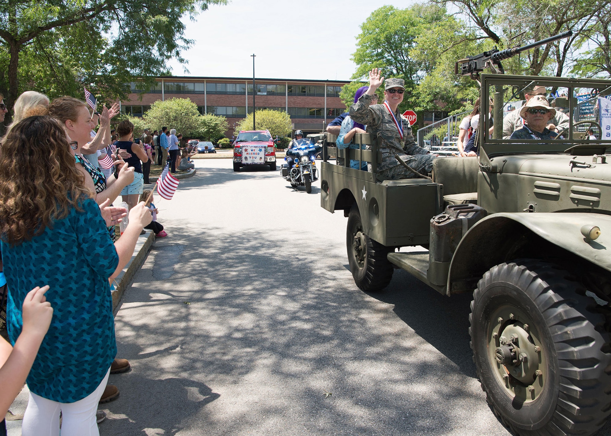 Master Sgt. Jessica LaBrie, 66th Air Base Group first sergeant, waves from a vintage military vehicle  during the Heroes Homecoming parade, July 21. Hanscom personnel gave a warm welcome home to the military and civilian personnel who have returned from deployment in the past year. (U.S. Air Force photo by Jerry Saslav)