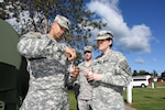 U.S. Army cadet Angel Camilo, 48th Combat Support Hospital, and Staff Sgt. Kellee Carraway, 789th Preventive Medicine Detachment training non-commissioned officer, check water chlorine levels in a water tank during the Greater Chenango Cares Innovative Readiness Training mission July 19, 2016, in Norwich, N.Y. In a field environment, the tank is used to provide a clean, drinkable water source in the event that local potable water isn't available. 