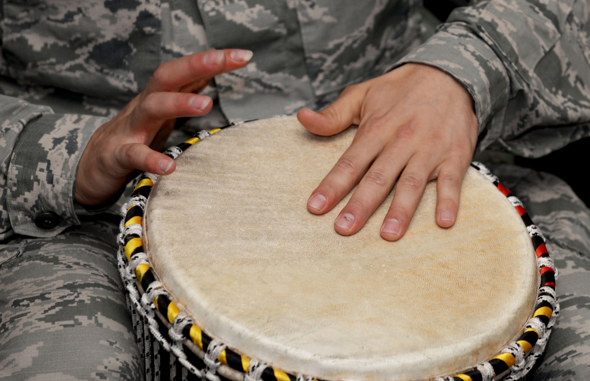 A U.S. Air Force Airman plays a bongo drum during Team Mildenhall’s Diversity Day celebration July 15, 2016, on RAF Mildenhall, England. The event highlighted many unique traditions and cultures all across the globe, such as Native American heritage, Black history and LGBT. (U.S. Air Force photo by Airman 1st Class Tenley Long)