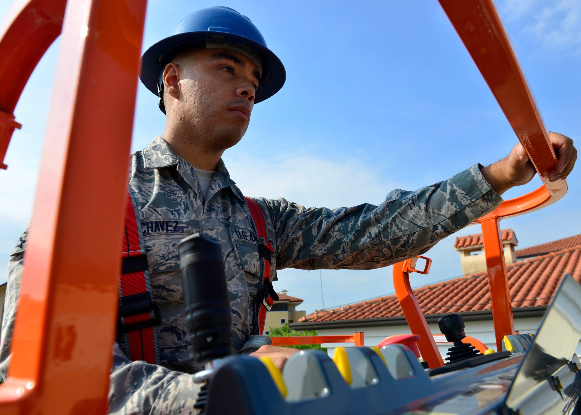 Airman 1st Class John Chavez, 31st Civil Engineer Squadron electrical systems journeyman, controls a lift truck used to install a lightning protection system, July 20, 2016, at Aviano Air Base, Italy. Electrical systems Airmen maintain and repair electrical components on base such as circuit outlets, office and street lights, and lightning protection systems. (U.S. Air Force photo by Airman 1st Class Cary Smith/Released)
