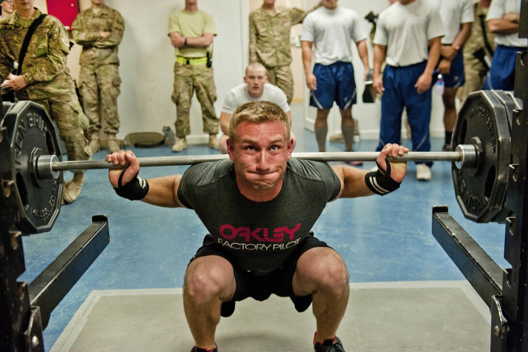 Peter Olsen, a Defense Department civilian, participates in the squat event portion of a powerlifting competition at Bagram Airfield, Afghanistan, July 15, 2016. Olsen is assigned to the 455th Expeditionary Aircraft Maintenance Squadron. Air Force photo by Capt. Korey Fratini