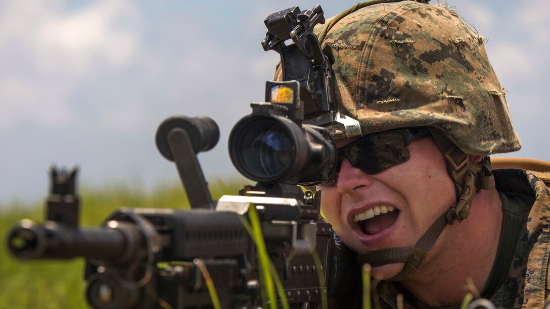 Lance Cpl. Collin J. O’Reilly simulates shooting a M240 Bravo during an airfield seizure exercise July 20, 2016 at Iejima, Okinawa, Japan. Marines immediately set up security, simulated engaging the enemy and set up a combat operations center after getting off an MV-22B Osprey. O’Reilly, a Colchester, Vermont, native, is a machine gunner with Golf Company, 2nd Marine Division currently attached to 4th Marine Regiment, 3rd Marine Division, III Marine Expeditionary Force through the unit deployment program. 