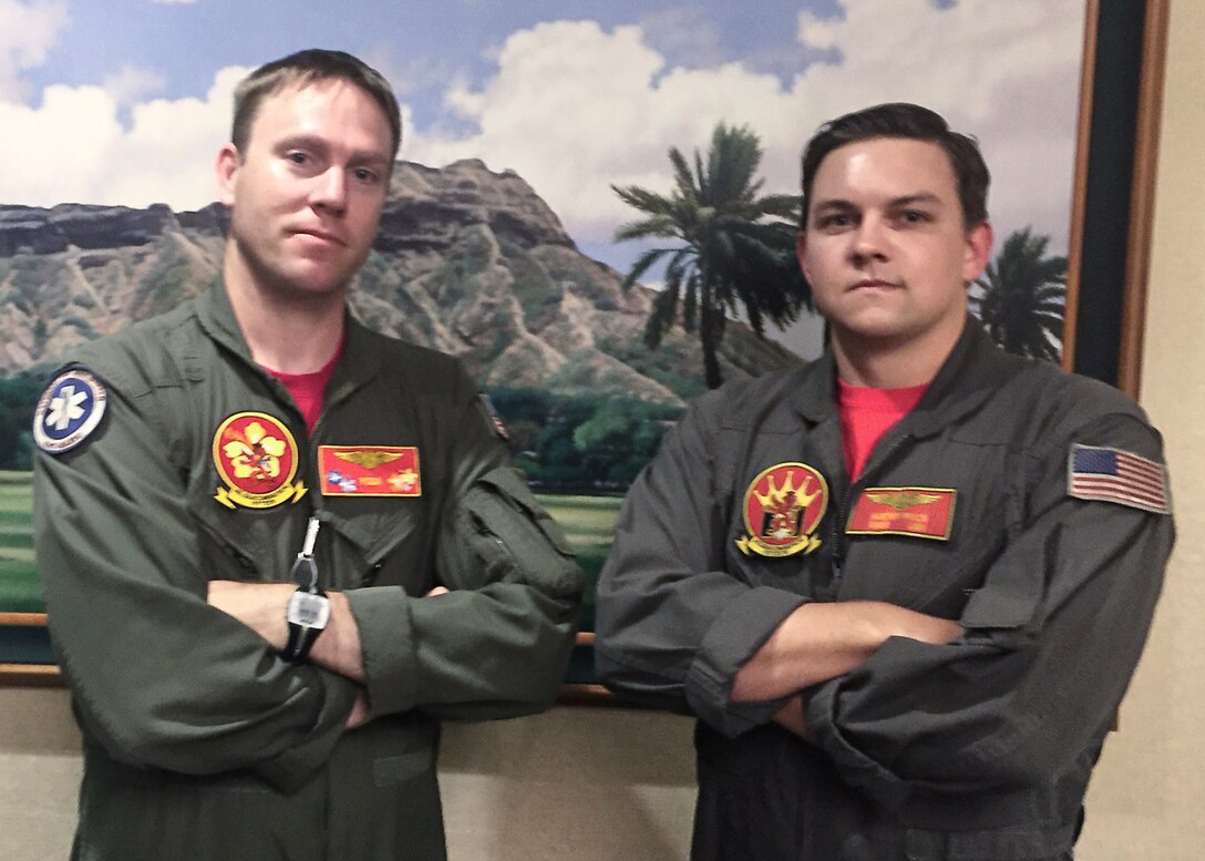 Navy Chief Petty Officer Jason Lessley, left, and Navy Petty Officer 2nd Class Hunter Price, both with Helicopter Sea Combat Squadron 15, provided emergency care to a tourist in medical distress on the Diamond Head Trail in Honolulu, July 12, 2016. Navy photo