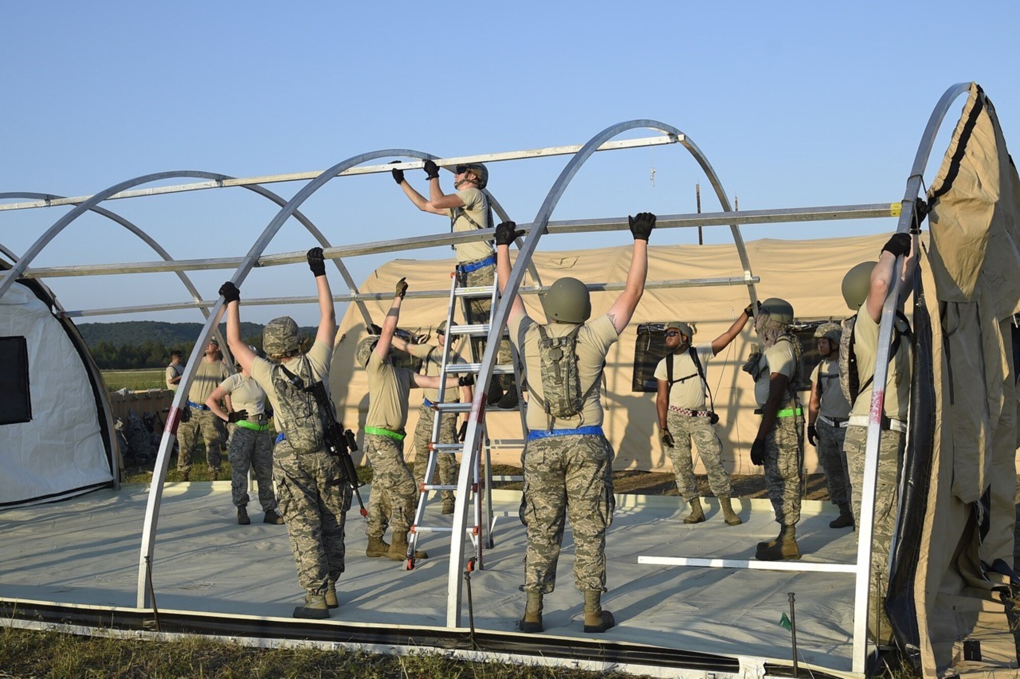 Airmen from the 621st Contingency Response Group, Joint Base-McGuire-Dix-Lakehurst, N.J., construct shelters during Joint Exercise Turbo Distribution at Fort McCoy, Wis., July 19, 2016. During the exercise, approximately 130 Airmen from the 621st Contingency Response Group, 50 Soldiers from the 689th Transportation Detachment Rapid Port Opening Element, Joint Base Langley-Eustis, Va., and a support team from the Defense Logistics Agency deployed as part of a Joint Task Force-Port Opening. 