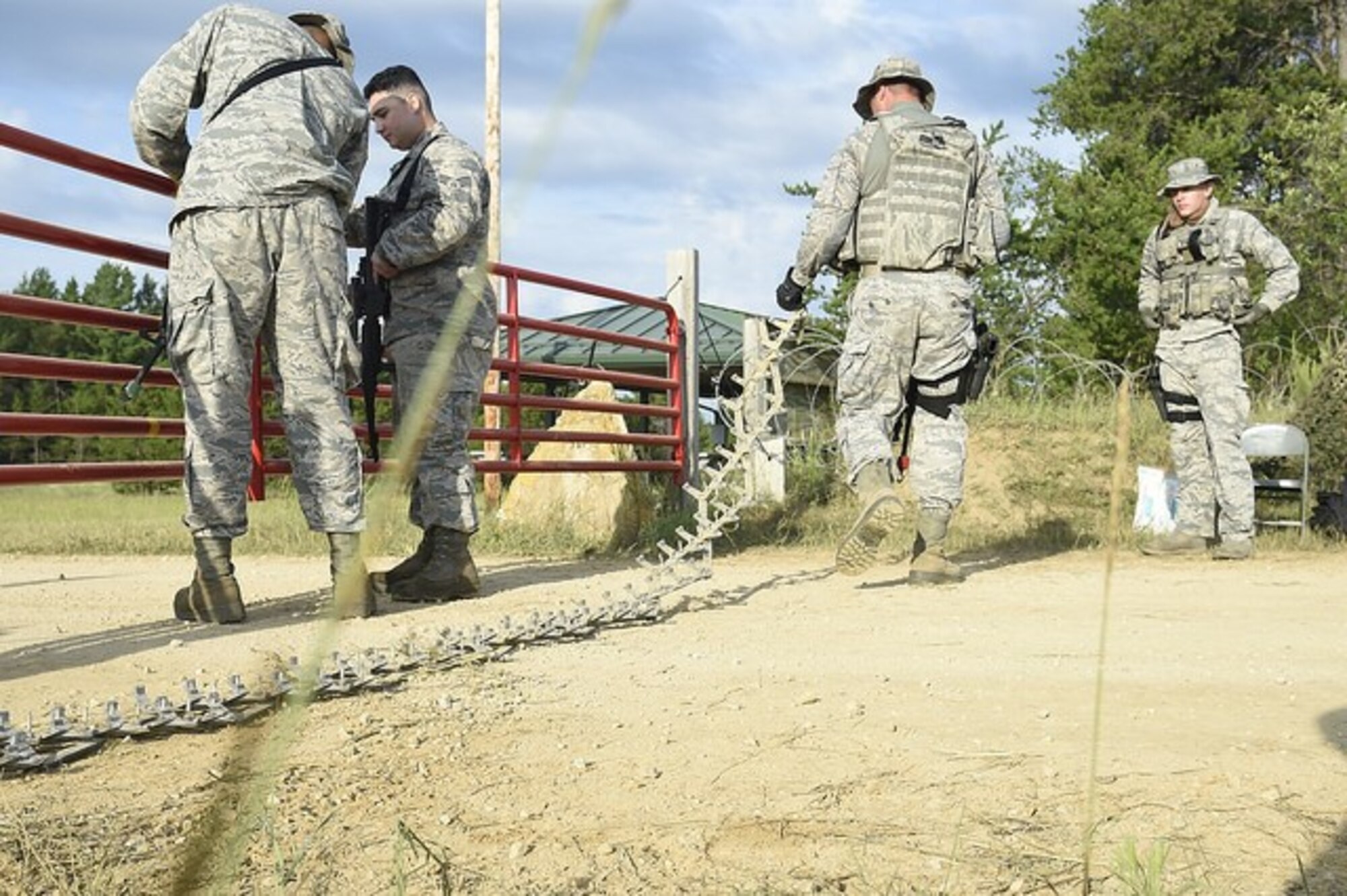 Airmen from the 621st Contingency Response Group, Joint Base McGuire-Dix-Lakehurst, N.J., establish an entry control point during Joint Exercise Turbo Distribution at Fort McCoy, Wis., July 19, 2016. During the exercise, approximately 130 Airmen from the 621st Contingency Response Group, 50 Soldiers from the 689th Transportation Detachment Rapid Port Opening Element, Joint Base Langley-Eustis, Va., and a support team from the Defense Logistics Agency deployed as part of a Joint Task Force-Port Opening. 