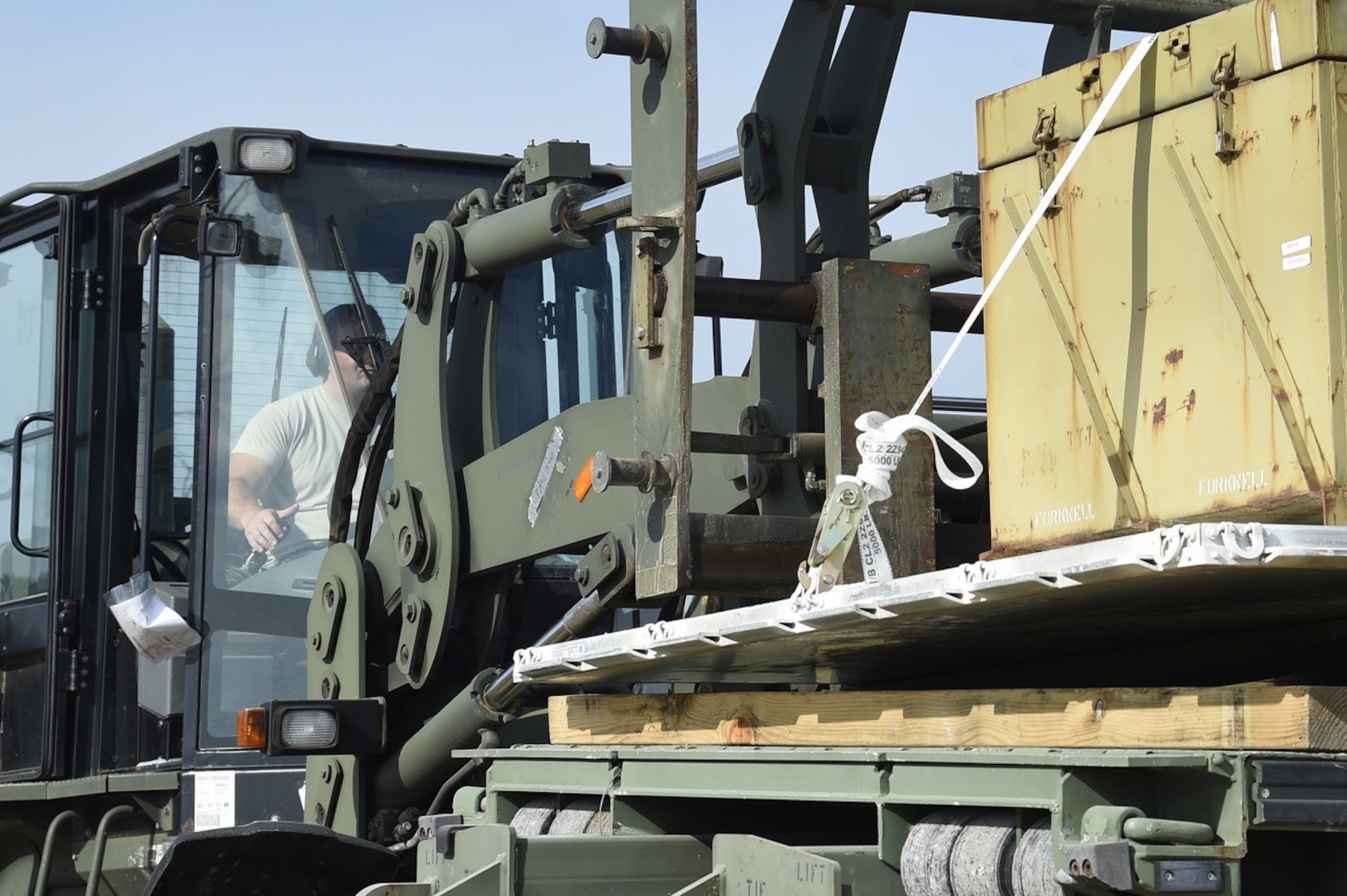 An Airman from the 621st Contingency Response Group, Joint Base McGuire-Dix-Lakehurst, N.J., operates a forklift while loading cargo during Joint Exercise Turbo Distribution at Fort McCoy, Wis., July 19, 2016. During the exercise, approximately 130 Airmen from the 621st Contingency Response Group, 50 Soldiers from the 689th Transportation Detachment Rapid Port Opening Element, Joint Base Langley-Eustis, Va., and a support team from the Defense Logistics Agency deployed as part of a Joint Task Force-Port Opening. 