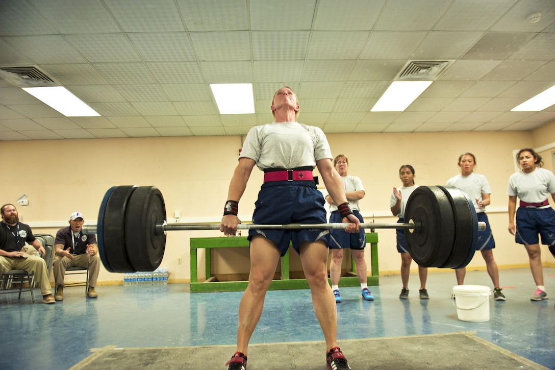 Air Force Master Sgt. Lindsey Glover lifts a barbell while performing a deadlift during a powerlifting competition at Bagram Airfield, Afghanistan, July 15, 2016. Glover is assigned to the 455th Expeditionary Aircraft Maintenance Squadron. Air Force photo by Capt. Korey Fratini 