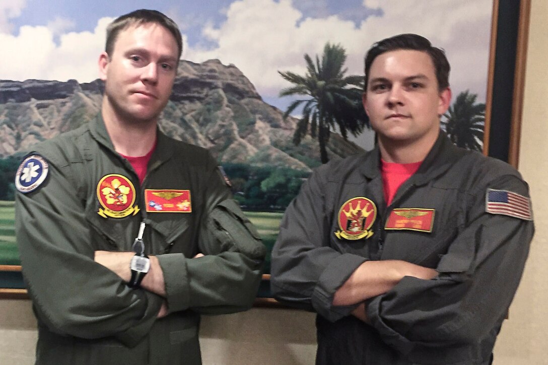 Navy Chief Petty Officer Jason Lessley, left, and Navy Petty Officer 2nd Class Hunter Price, both with Helicopter Sea Combat Squadron 15, provided emergency care to a tourist in medical distress on the Diamond Head Trail in Honolulu, July 12, 2016. Navy photo