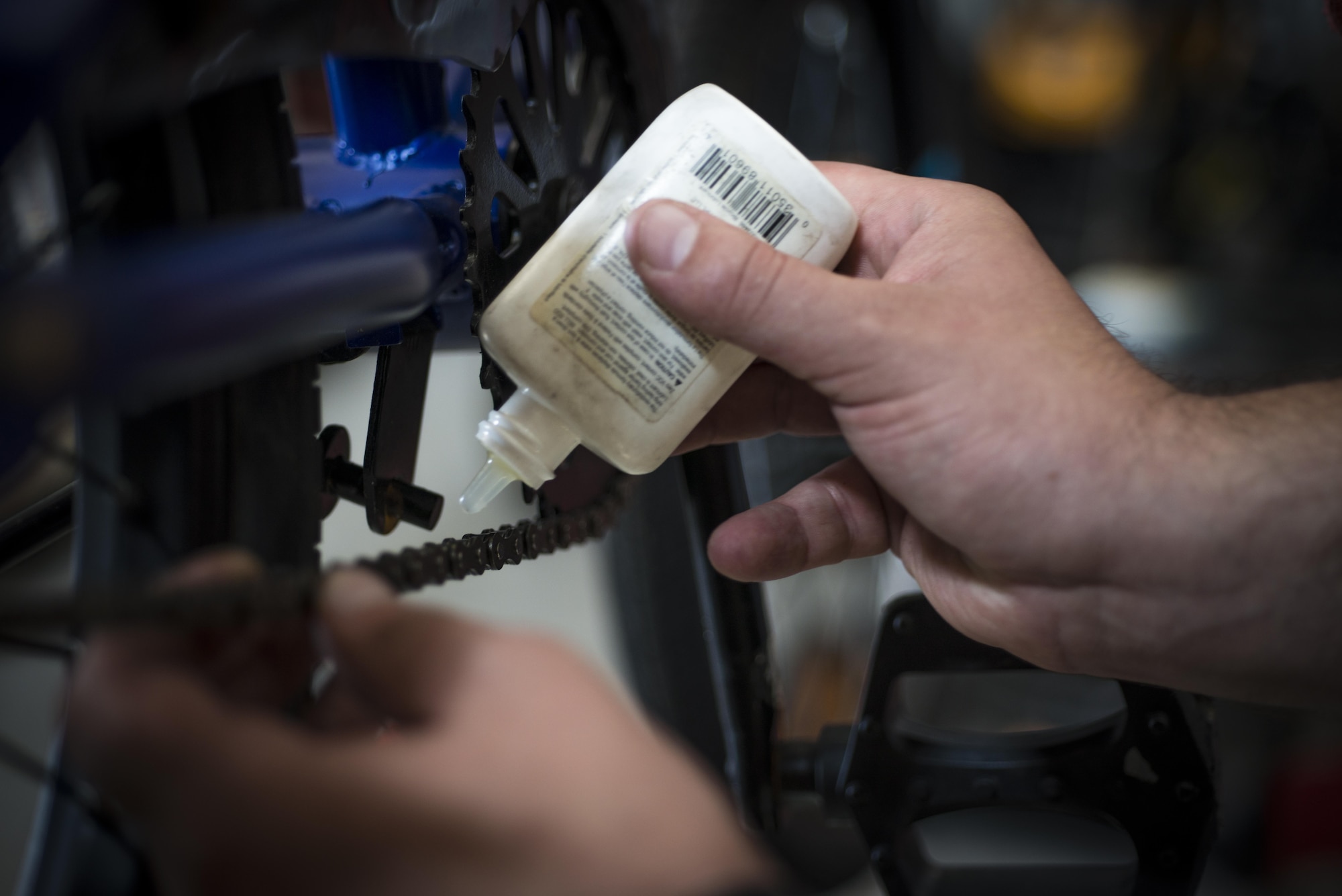 Todd Spencer, 31st Force Support Squadron Outdoor Recreational equipment maintenance professional, applies lubricant to a customer’s bicycle chain July 20, 2016, at Aviano Air Base, Italy. Outdoor Recreation offers European outdoor adventures trips for Team Aviano members during their time here. (U.S. Air Force photo by Airman 1st Class Cory W. Bush/Released)