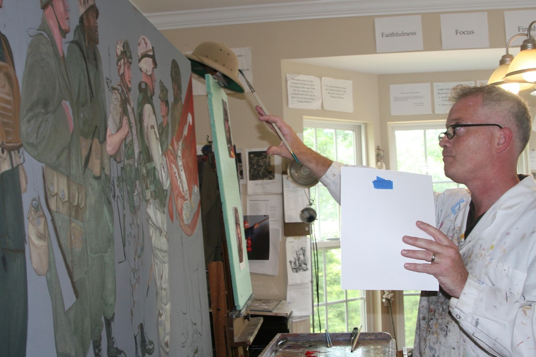 Kristopher Battles, a veteran Marine combat artist, works on the painting he was commissioned to paint for the Centennial celebration of the U.S. Marine Corps Reserves in his Spotsylvania, Va. studio July 18.