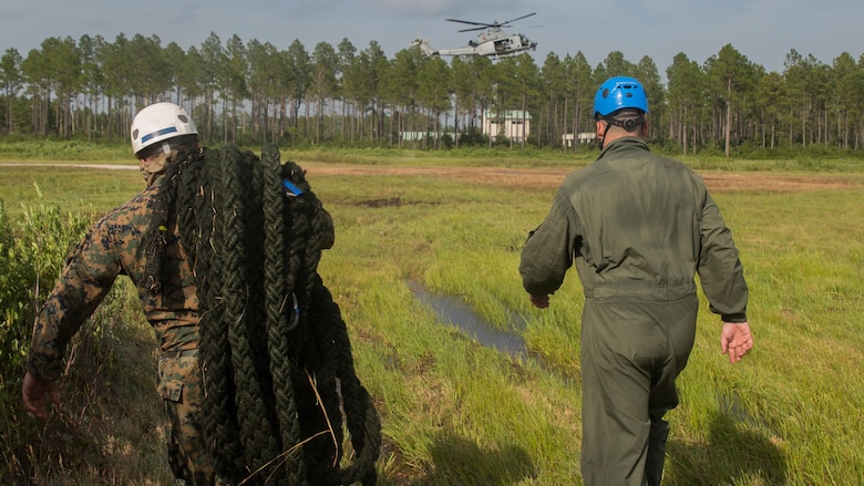 Marine instructors with Expeditionary Operations Training Group approach a UH-Y1 Huey in preparation for fast rope drills during elevator operations at Landing Zone Kingfisher, Marine Corps Base Camp Lejeune, N.C., July 13, 2016. The fast rope masters course, a week-long training event, is the first of its kind and focuses solely on techniques, procedures, and safety that comes along with fast roping with a combat load.