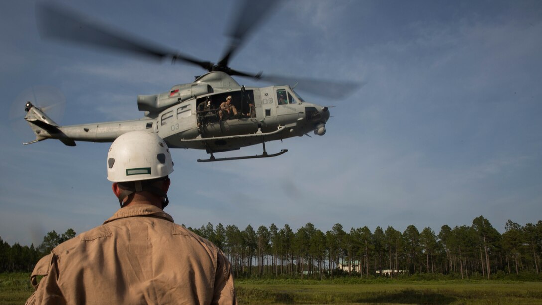 A UH-Y1 Huey hovers 30-40 feet above the ground during fast rope drills at Landing Zone Kingfisher, Marine Corps Base Camp Lejeune, N.C., July 13, 2016. Marines with Expeditionary Operations Training Group went through a week-long fast rope masters course which qualifies them to conduct fast rope training within their subordinate command.