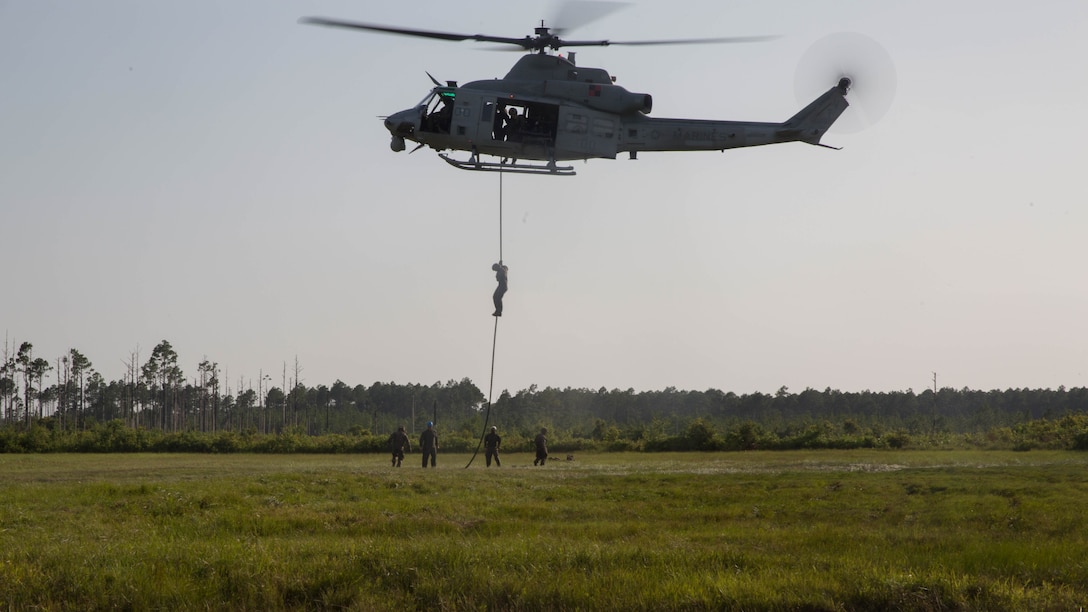 Marine students with the Fast Rope Masters Course, ran by Expeditionary Operations Training Group rappel from a UH-Y1 Huey helicopter during elevator drills at Landing Zone Kingfisher, Marine Corps Base Camp Lejeune, N.C., July 13, 2016. The week-long course is the first of its kind and focuses on qualifying Marines as subject matter experts and gives them the ability to execute fast rope training within their subordinate command.