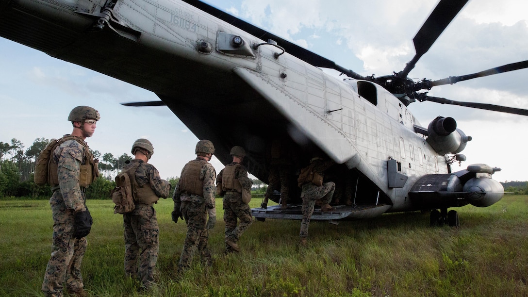 Marine students with the Fast Rope Masters Course, ran by Expeditionary Operations Training Group, enter a CH-53E Super Stallion helicopter during elevator drills at Landing Zone Kingfisher, Marine Corps Base Camp Lejeune, N.C., July 13, 2016. The week-long course is the first of its kind and focuses on qualifying Marines as subject matter experts and gives them the ability to execute fast rope training within their subordinate command.