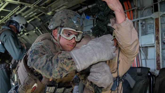 A Marine student with the Fast Rope Masters Course, ran by Expeditionary Operations Training Group prepares to fast rope out of the "hell hole" in a CH-53E Super Stallion helicopter during elevator operations at Landing Zone Kingfisher, Marine Corps Base Camp Lejeune, N.C., July 13, 2016. The fast rope masters course is a new course offered by EOTG and teaches Marines how to properly conduct fast rope operations from structures as well as rotary wing aircraft.