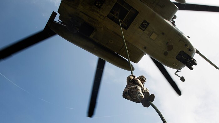 A Marine student with the Fast Rope Masters Course, ran by Expeditionary Operations Training Group fast ropes out of a CH-53E Super Stallion helicopter during elevator operations at Landing Zone Kingfisher, Marine Corps Base Camp Lejeune, N.C., July 13, 2016. The new course is a shortened version of the helicopter rope suspension training course and focuses on qualifying Marines as subject matter experts within their subordinate command.