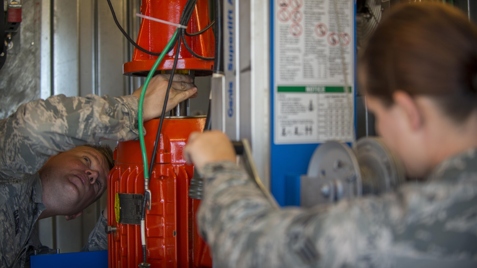 Staff Sgt. Adam Gagnon, 31st Operations Support Squadron NCO in charge of ground radar systems, and Senior Airman Checotah Lovelace, 31st OSS ground radar systems technician, remove a broken motor from a digital airport surveillance radar system July 19, 2016, at Aviano Air Base, Italy. The radar detects aircraft positions and weather conditions within 60 nautical miles of Aviano. (U.S. Air Force photo by Airman 1st Class Cory W. Bush/Released)