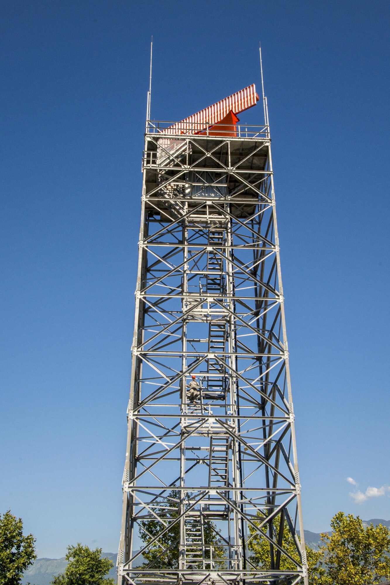 Senior Airman Checotah Lovelace, 31st Operations Support Squadron ground radar systems technician and Staff Sgt. Adam Gagnon, 31st OSS NCO in charge of ground radar systems, climb down a digital airport surveillance radar tower July 20, 2016, at Aviano Air Base, Italy. The 31st OSS is preparing to replace one of the two motors that power the radar. (U.S. Air Force photo by Airman 1st Class Cory W. Bush/Released)